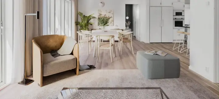 Ett ljust och luftigt vardagsrum med matplats i klassisk nordisk design. En bekväm fåtölj och en grön pall skapar en inbjudande atmosfär.